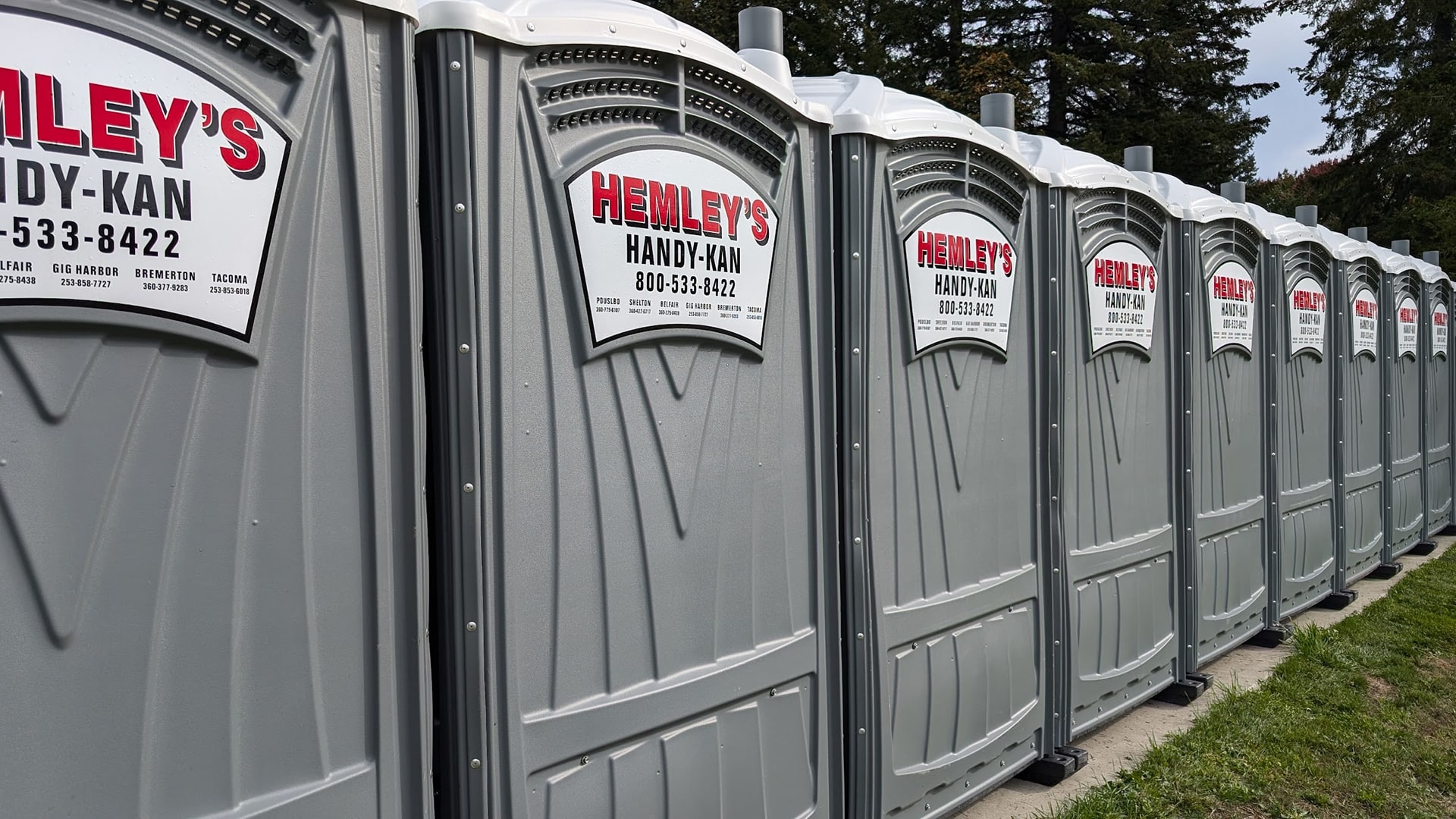 Row of Grey Hemley's Portable Toilet Rentals